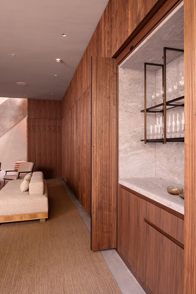 Metal-framed glass shelving in a timber kitchen