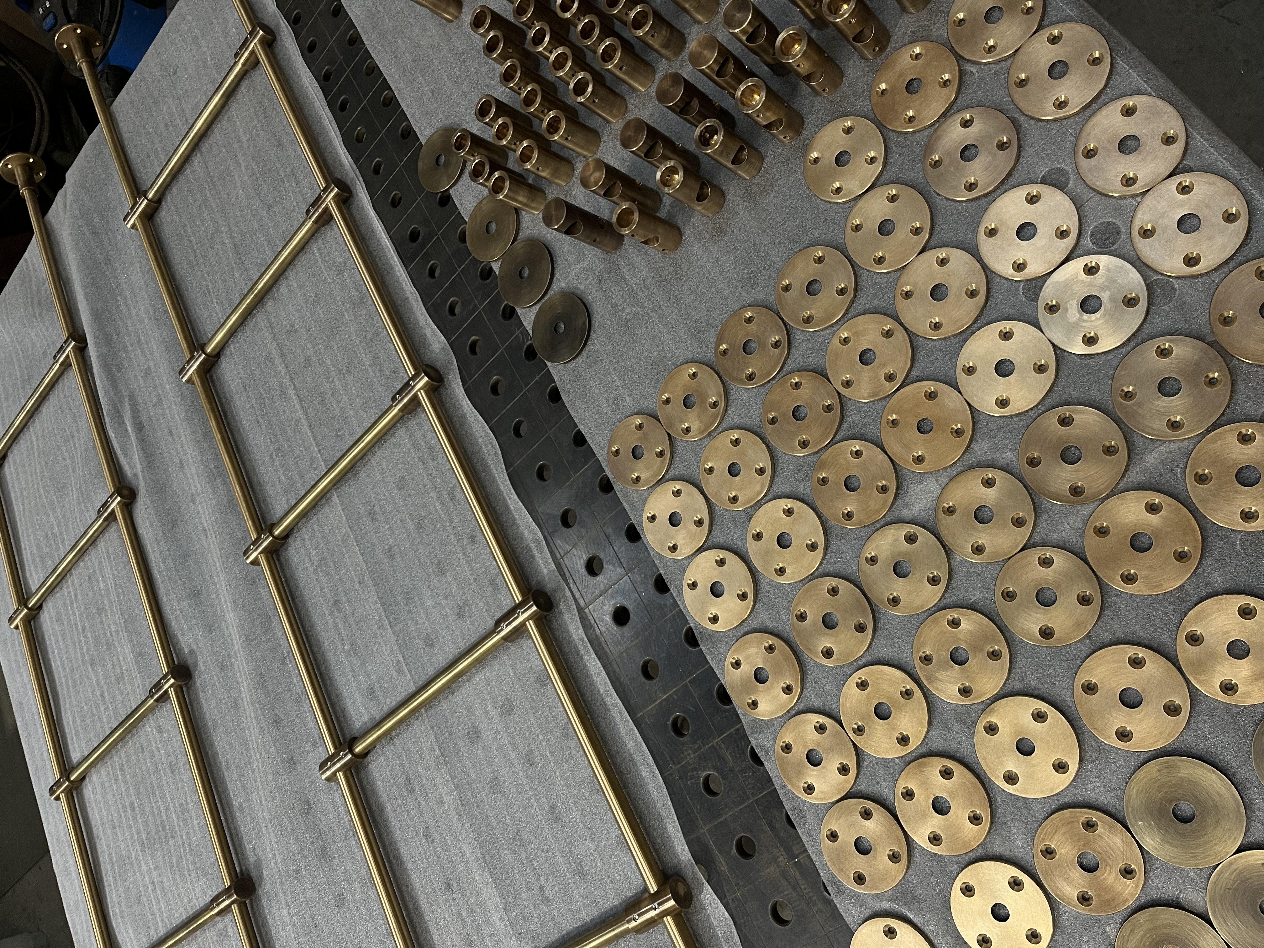 Workshop assembly of brass shelving components