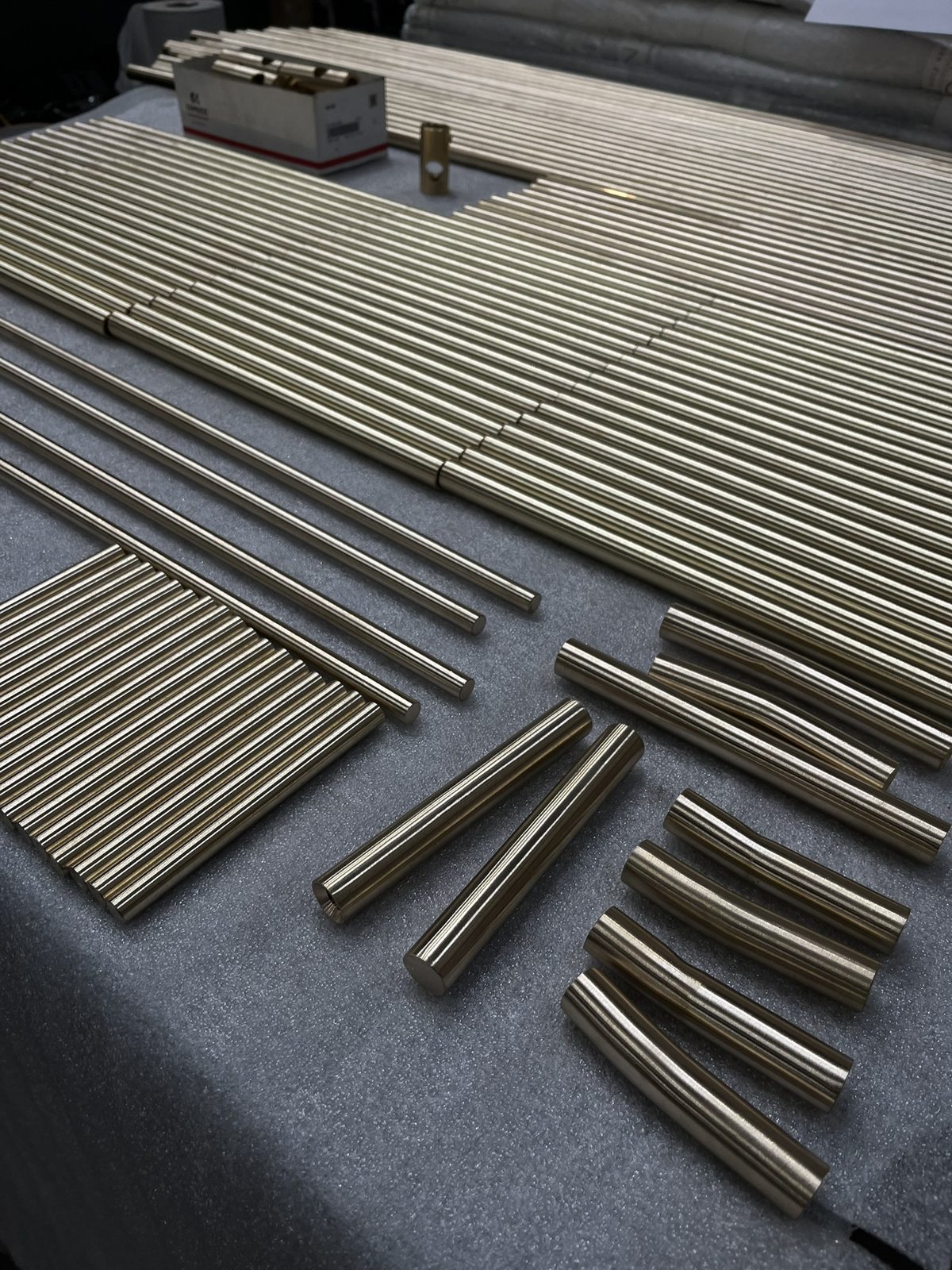 Lengths of brass bar cut to size and laid out on the bench