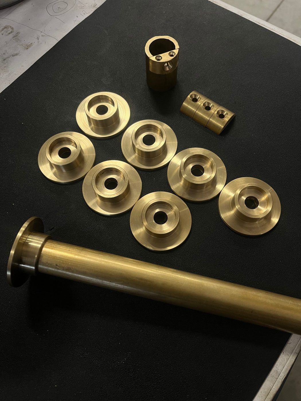 Turned brass plates and collars on the bench